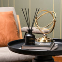Jameela Reed diffuser in a stylish setting with jasmine tuberose diffuser surrounded by books and decor.